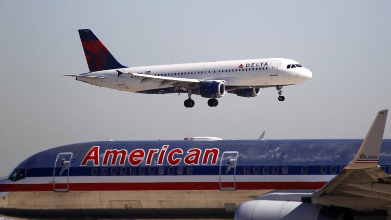 A Delta Airlines jet comes in for landing over an American Airlines jet at Dallas Fort Worth International Airport. LM Otero / AP Photo