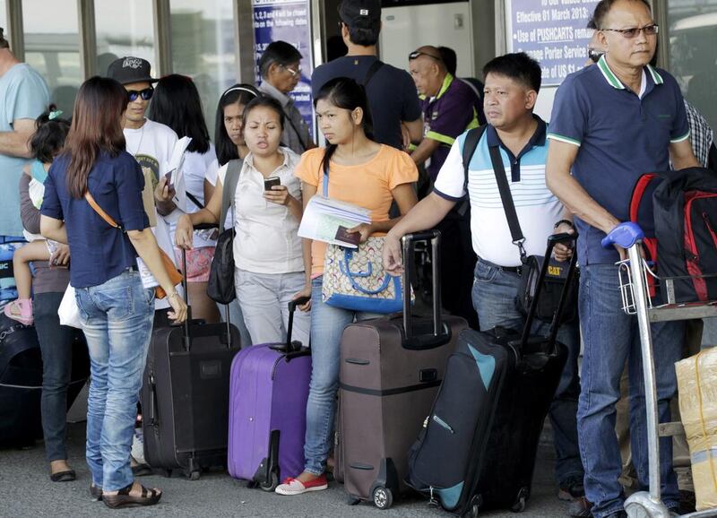 Overseas Filipino workers (prepare to board a flight in Manila. (Romeo Ranoco / Reuters)