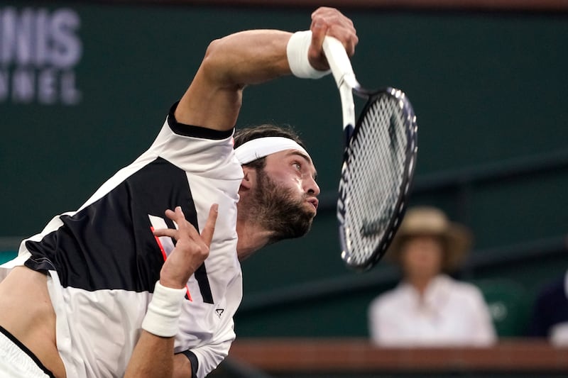 Nikoloz Basilashvili, of Georgia, serves against Cameron Norrie, of Britain. AP Photo