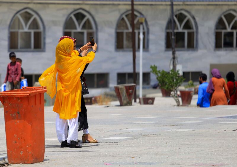 Afghan women take a selfie at a park in Kabul. The rates of child, early and forced marriage in Afghanistan are increasing under Taliban rule, Amnesty International has said. EPA