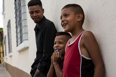 Migrants from Honduras wait outside the Migrant's House shelter in Guatemala City, Friday, July 26, 2019. AP