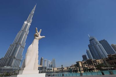 An artwork called in front of Burj Khalifa. The three finger hand gesture, coined by Sheikh Mohammed bin Rashid, means Win, Victory and Love. AFP