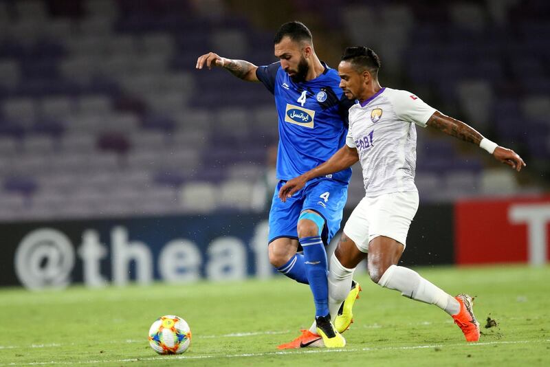 epa07587795 Caio Lucas Fernandes (R) of Al Ain FC in action against Roozbeh Cheshmi of Esteghlal F.C. during the AFC Champions League group C soccer match between Al Ain FC and Esteghlal Tehran F.C. in Al Ain, United Arab Emirates, 20 May 2019.  EPA/ALI HAIDER