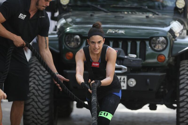 Dana Shamlawi pulls a 4x4 car during the final day of the UAE Strongman Competition in Dubai. Delores Johnson / The National