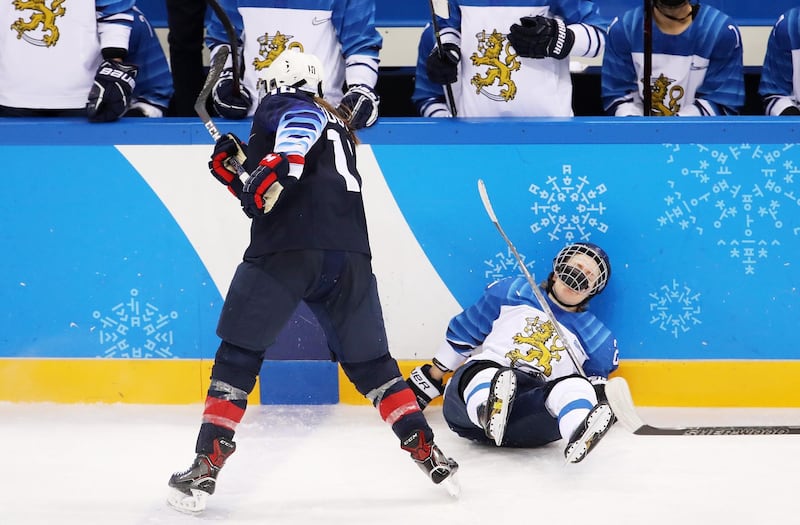 Meghan Duggan, number 10 of the United States, checks Noora Tulus, number 24 of Finland, into the boards during the Ice Hockey Women Play-offs semi-finals on day 10 of the PyeongChang 2018 Winter Olympic Games at Gangneung Hockey Centre. Bruce Bennett / Getty Images