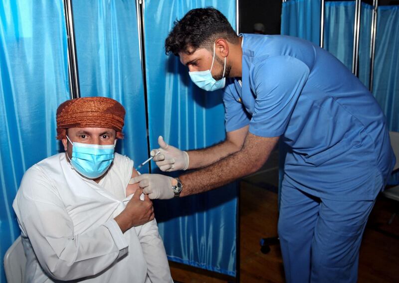 An Omani man receives a dose of the Pfizer/BioNTech Covid-19 vaccine at the Sultan Qaboos Sports Complex in Oman's capital Muscat. AFP