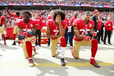 epa05620893 YEARENDER 2016 OCTOBER 
San Francisco 49ers back-up quarterback Colin Kaepernick (C), San Francisco 49ers outside linebacker Eli Harold (L), and San Francisco 49ers free safety Eric Reid (R) take a knee during the US national anthem before the NFL game between the Dallas Cowboys and the San Francisco 49ers at Levi's Stadium in Santa Clara, California, USA, 02 October 2016. Kaepernick is protesting police brutality and oppression in America.  EPA/JOHN G MABANGLO *** Local Caption *** 53107662