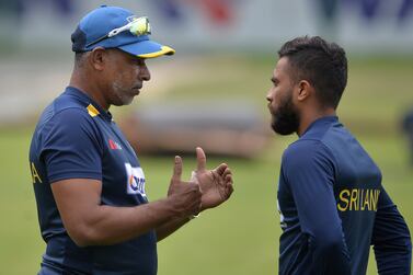 Sri Lanka’s bowling coach Chaminda Vaas (L) talks to Kusal Mendis (R) during a training session in Sher-e-Bangla National Cricket Stadium in Dhaka in May 26, 2021.
