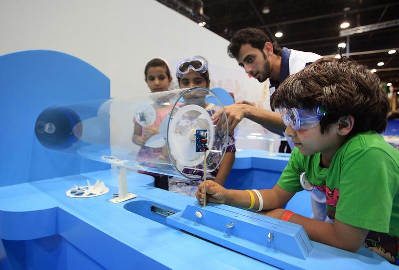 Young students experiment with wind turbines at last year's Abu Dhabi Science Festival held at Abu Dhabi National Exhibition Centre. Ravindranath K / The National