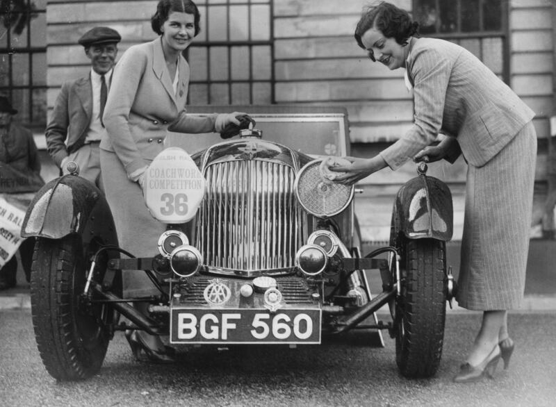 Two women polish their Aston Martin sports car at the Welsh Motor Rally in Cardiff, 1935. All photos: Getty Images
