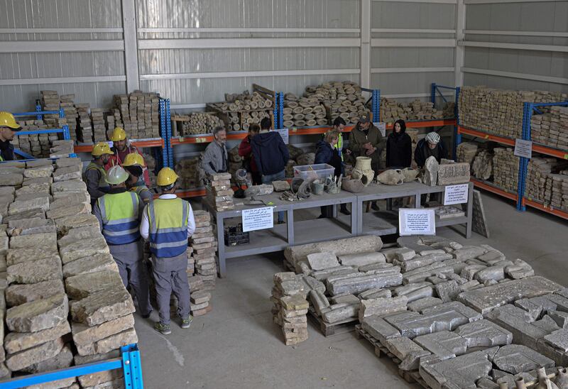 Foreign tourists and envoys from Unesco visit a warehouse containing remains of archaeological artifacts from Al Nuri Mosque in Mosul, northern Iraq.