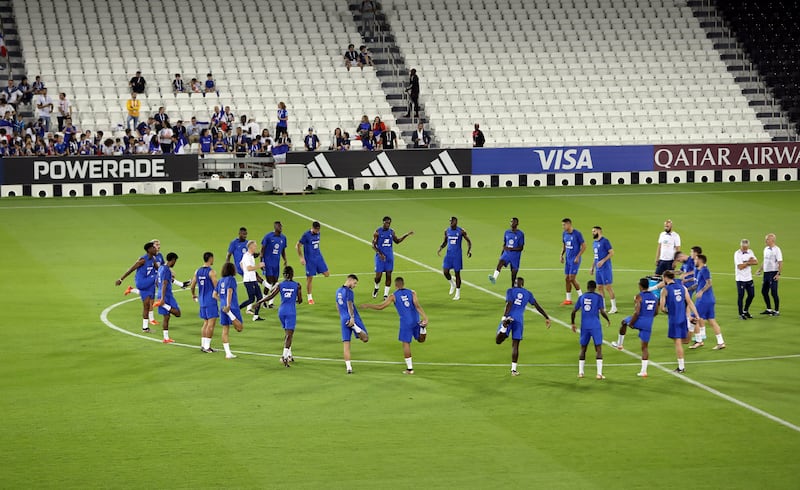 The France squad stretch during training. EPA
