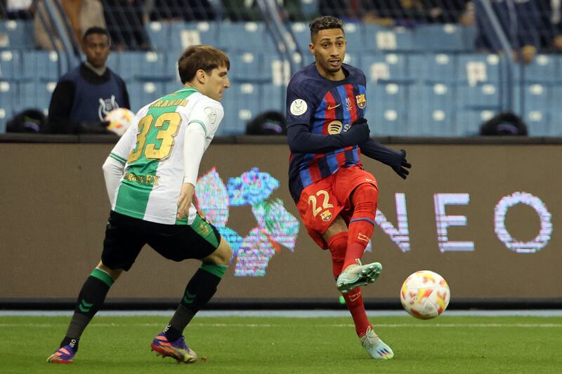 Barca forward Raphinha is challenged by Juan Miranda. AFP