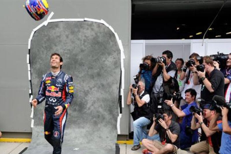 The flip side of Formula One racing for the drivers is the waiting between races. With the season finally about to start Sunday with the Australian Grand Prix, Red Bull's Mark Webber is having fun with it as photographers snap away.