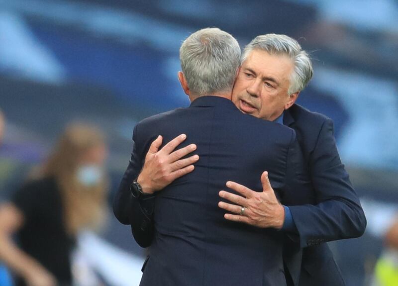 Everton manager Carlo Ancelotti hugs his Spurs counterpart Jose Mourinho after the match. Reuters