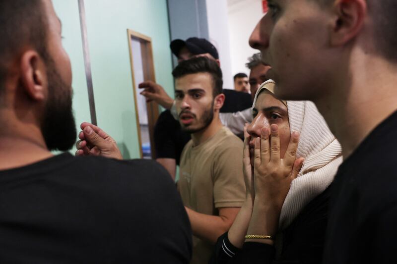 People wait for news of the injured at a hospital in Jenin. AFP