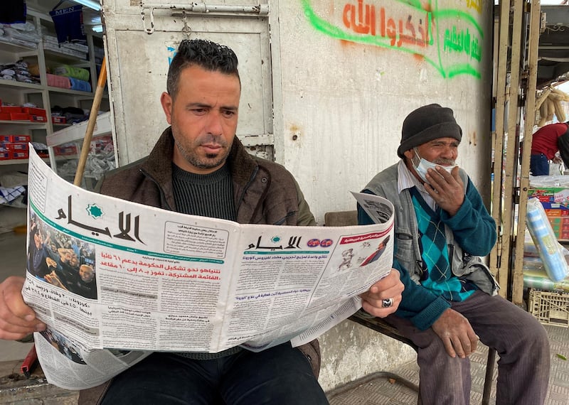 A Palestinian man reads a newspaper with the front-page headline about the results of the Israeli election, in Gaza City. Reuters