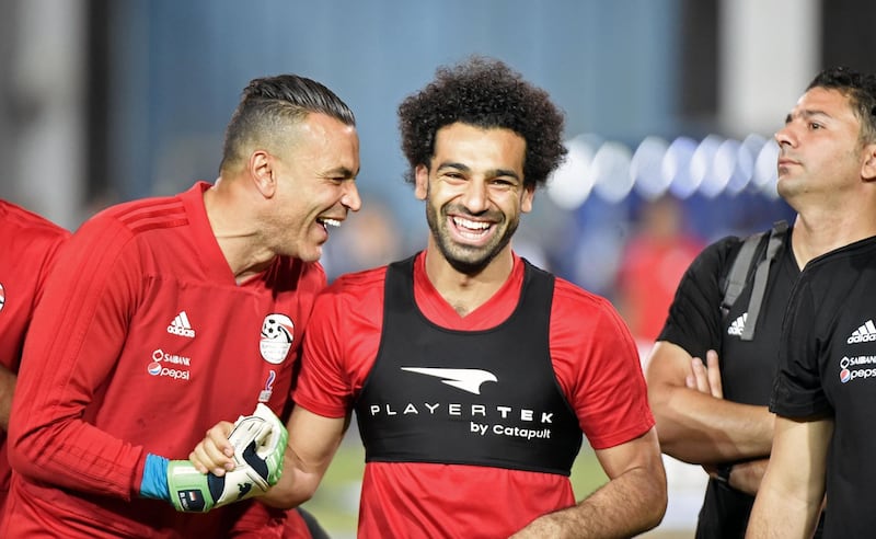 Mohamed Salah shares a joke with goalkeeper Essam el-Hadary. Khaled Desouki / AFP