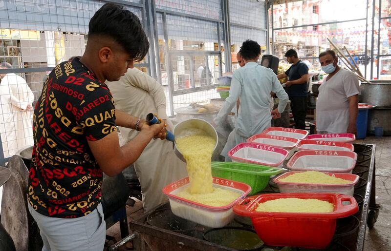 Volunteers prepare meals for a free communal iftar on a street in Najaf, Iraq. Reuters