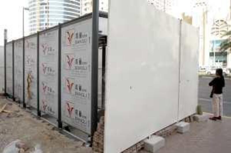 ABU DHABI, UNITED ARAB EMIRATES - June 24, 2009: A partially constructed bus shelter across from Al Wahda Mall on 11th Street will have air conditioning.
( Ryan Carter / The National )

*** for story by Matt Chung *** Local Caption ***  RC006-AirConShelter.JPG