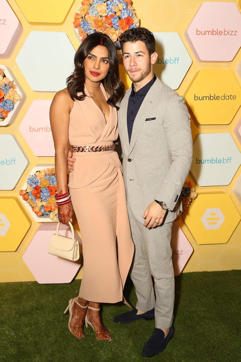 Indian Bollywood actress Priyanka Chopra (L) with her husband US musician Nick Jonas pose for a picture at Bumble's launch party, in New Delhi on December 05, 2018. / AFP / Pallav Paliwal
