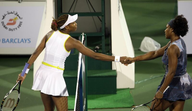 Venus (L) and Serena (R) Williams of the US shake hands following their WTA Dubai Tennis Championships semi final match in the Gulf emirate on February 20, 2009. Venus won the match 6-1, 2-6, 7-6 after the sisters earned the right to play each other for the 19th time. Venus will face France's Virginie Razzano in the final. AFP PHOTO/KARIM SAHIB (Photo by KARIM SAHIB / AFP)