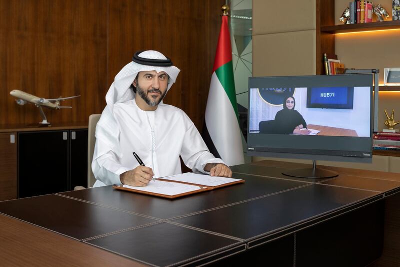 Mohammad Al Bulooki, Etihad Aviation Group COO and Hanan Al Yafei Hub71 CEO sign MOU LR. Courtesy Etihad