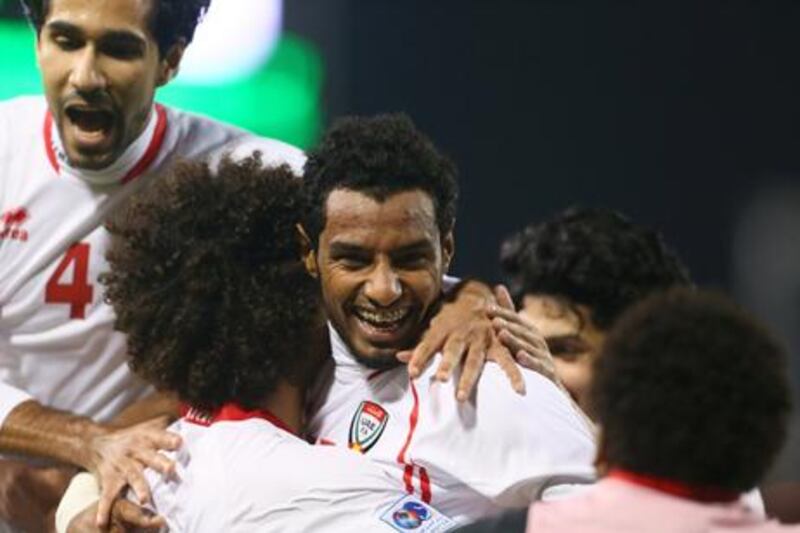 The UAE's Mohammed Ahmed celebrates with teammates after scoring the third goal in their opening Gulf Cup of Nations match.