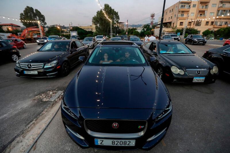 Lebanese youths wait in their cars to watch a movie at a drive-in cinema at a park in the coastal town of Byblos. AFP