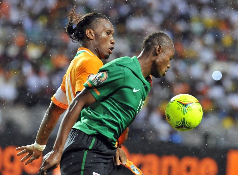 Stoppila Sunzu, right, defends Didier Drogba during a 2012 Africa Cup of Nations match. Issouf Sanogo / AFP