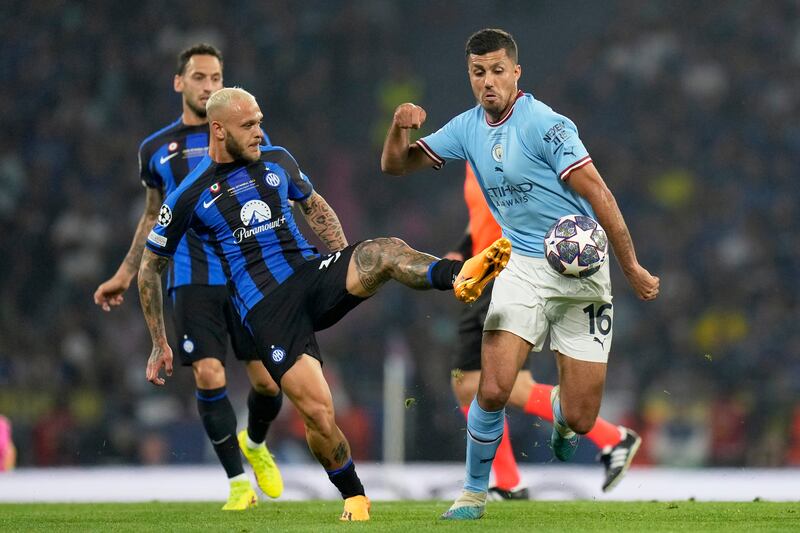 Inter Milan's Federico Dimarco vies for the ball with Manchester City's Rodri. AP