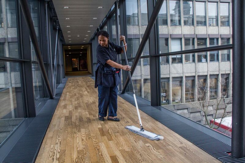 An employee of ISS A/S, the world's largest cleaning services company, cleans the hallway of an office building in Copenhagen, Denmark, on Thursday, Feb. 27, 2014. The cost of insuring against a default on debt sold by ISS A/S dropped to the lowest in nine years as owners Goldman Sachs Capital Partners and the billionaire behind Lego A/S target a public share sale. Photographer: Freya Ingrid Morales/Bloomberg via Getty Images