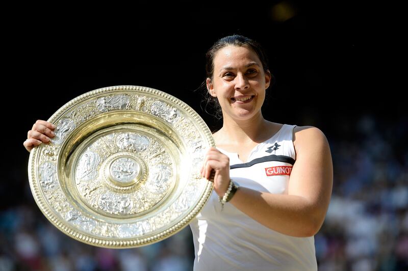 LONDON, ENGLAND - JULY 06:  Marion Bartoli of France poses with the Venus Rosewater Dish trophy after her victory in the Ladies' Singles final match against Sabine Lisicki of Germany on day twelve of the Wimbledon Lawn Tennis Championships at the All England Lawn Tennis and Croquet Club on July 6, 2013 in London, England.  (Photo by Dennis Grombkowski/Getty Images) *** Local Caption ***  173069228.jpg