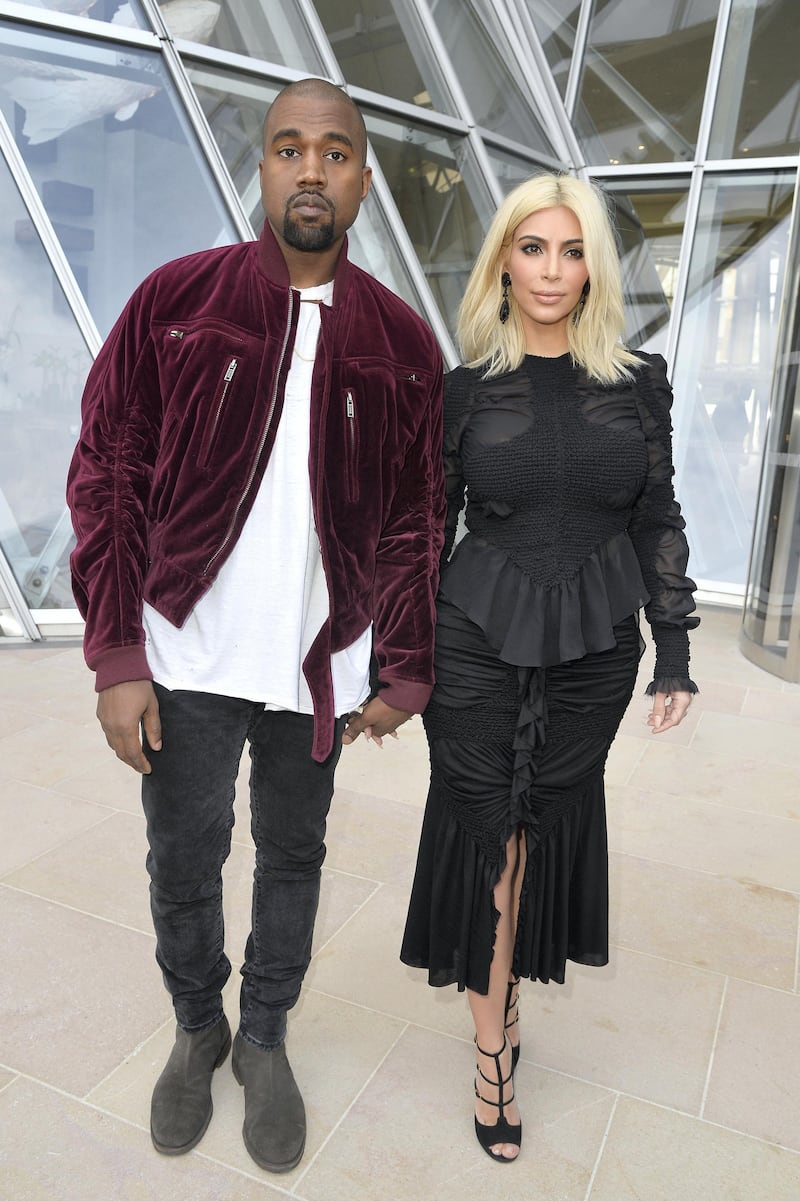PARIS, FRANCE - MARCH 11:  (L-R) Kanye West and Kim Kardashian attend the Louis Vuitton  show as part of the Paris Fashion Week Womenswear Fall/Winter 2015/2016 on March 11, 2015 in Paris, France.  (Photo by Pascal Le Segretain/Getty Images)