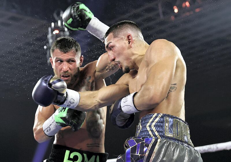 LAS VEGAS, NEVADA - OCTOBER 17: In this handout image provided by Top Rank, Teofimo Lopez Jr punches Vasiliy Lomachenko in their Lightweight World Title bout at MGM Grand Las Vegas Conference Center on October 17, 2020 in Las Vegas, Nevada. (Photo by Mikey Williams/Top Rank via Getty Images)