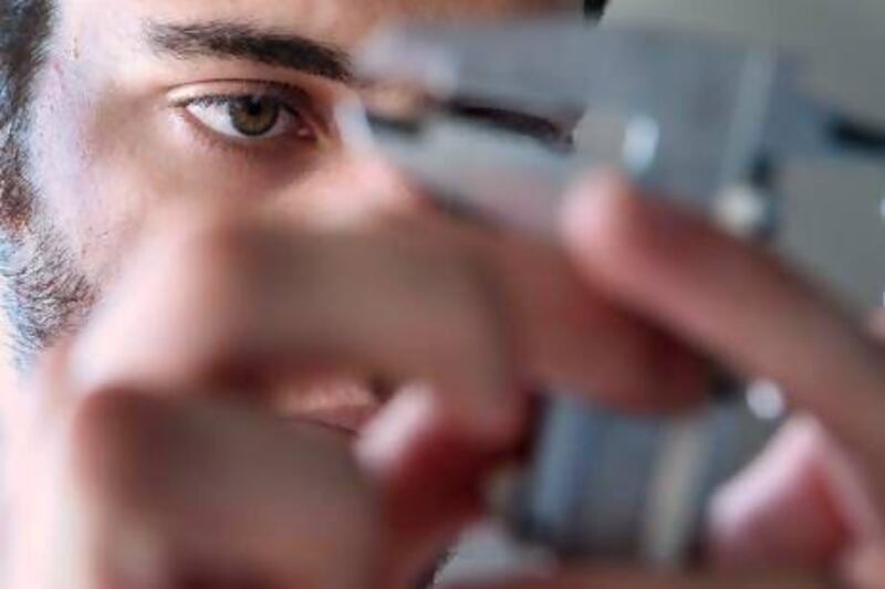 Rodrigo Ceballos, 19, calibrates an instrument. Delores Johnson / The National