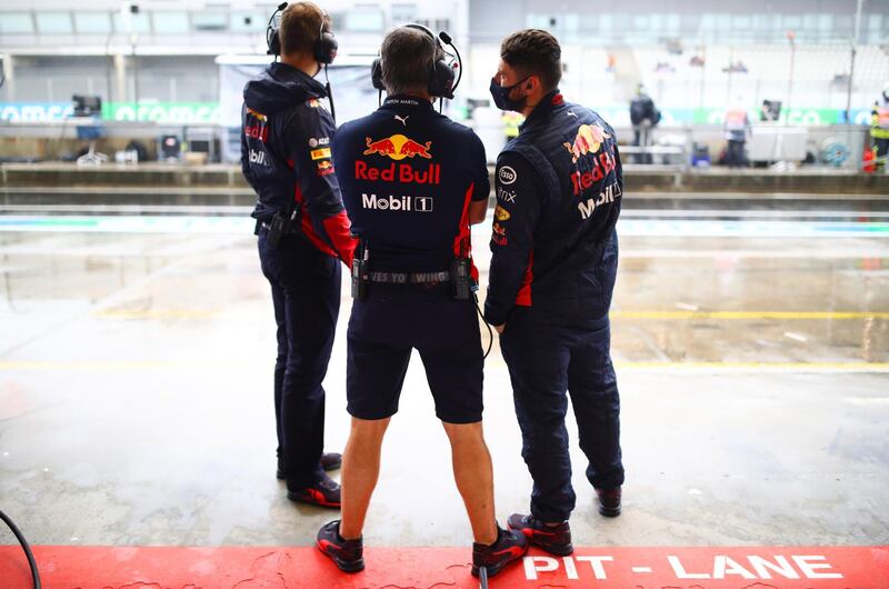 Red Bull Racing team members look at the pitlane. Getty