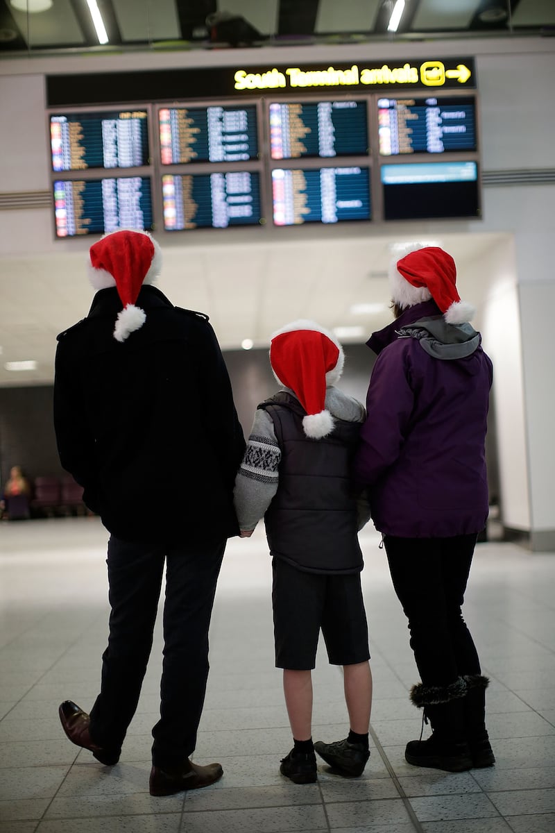 A family look at the arrivals board during the 2013 Christmas period