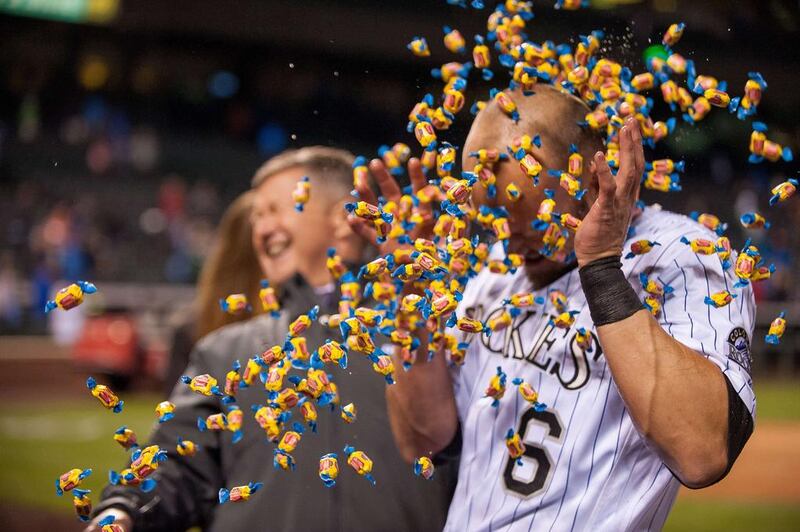 Ryan Raburn (No 6) of the Colorado Rockies showered with candy bubblegum after hitting an 11th inning walk off double against the Chicago Cubs at Coors Field in Denver, Colorado. The Rockies beat the Cubs 7-6. Dustin Bradford / Getty Images / AFP