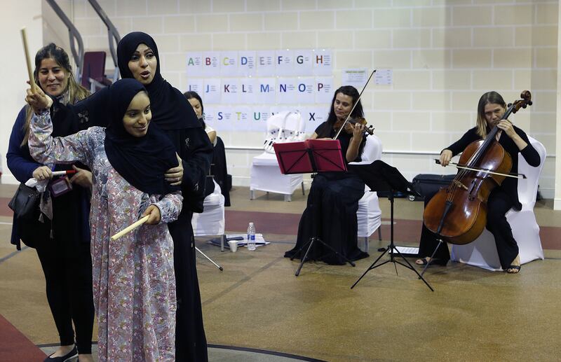 UAE composer Eman Al Hashimi works with children with autism on May 19, 2017, during a musical workshop at New England Centre in Abu Dhabi. Ravindranath K / The National