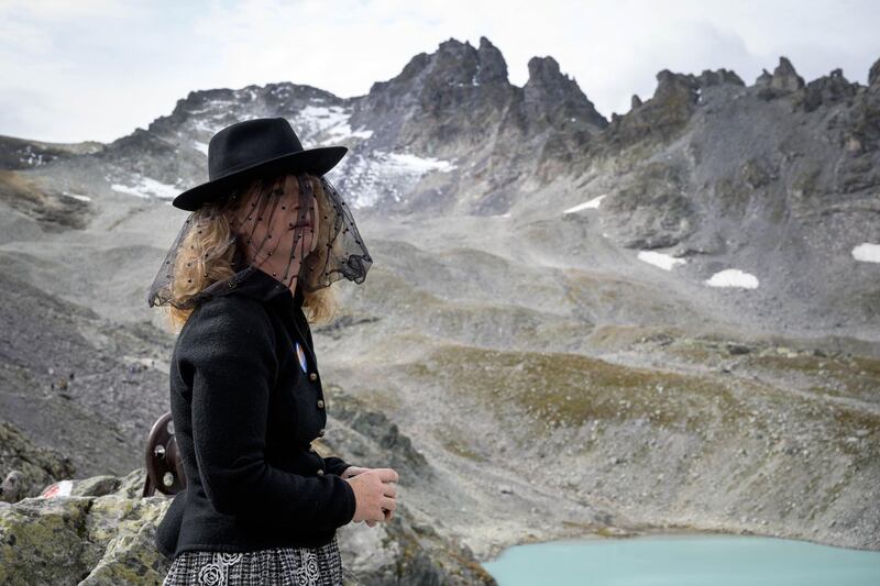 A woman takes part in a ceremony to mark the 'death' of the Pizol glacier (Pizolgletscher) above Mels, eastern Switzerland. AFP