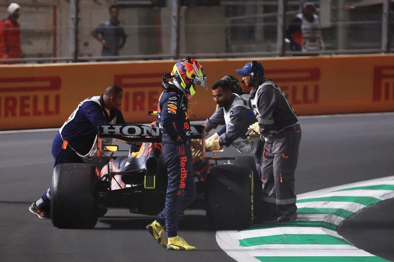 Red Bull driver Sergio Perez  leaves his car after a collision. AFP