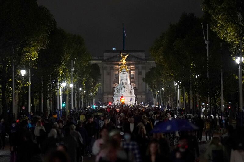 Londoners walk down The Mall that leads to Buckingham Palace on Thursday night. PA