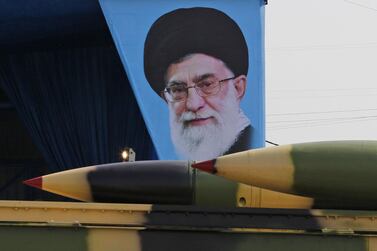 An Iranian military lorry carries surface-to-air missiles past a portrait of Iran's Supreme Leader Ayatollah Ali Khamenei during a parade. AFP