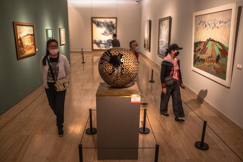 Museum goers wearing protective face masks visit 'A tribute to donors' exhibition at the National Art Museum of China on the first day after reopening.  EPA/ROMAN PILIPEY
