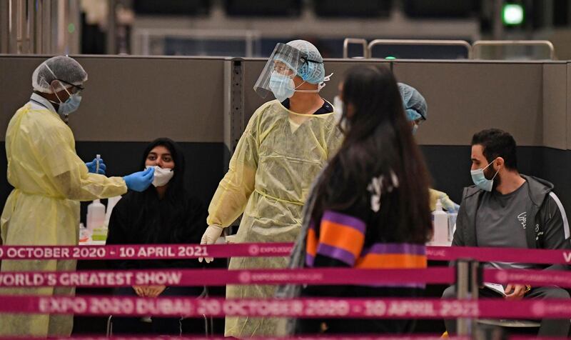 Health workers check passengers. AFP
