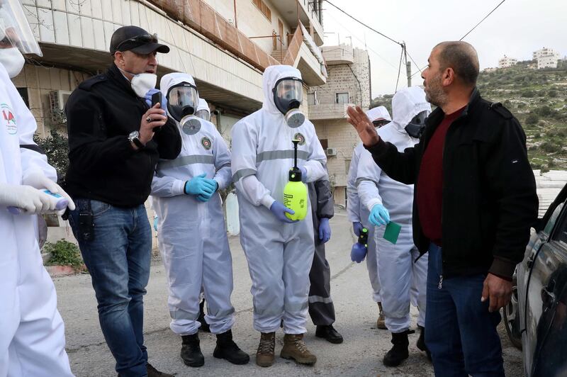 Palestinian security forces arrest a Palestinian man who has not adhered to the house quarantine for 14 days, and takes him to a detention centre in the city of Hebron in the West Bank.  EPA