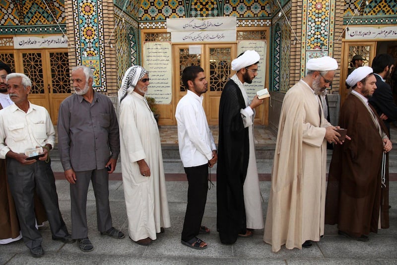 Men stand in line to vote during the Iranian presidential election at a mosque in Qom, 120 km (74.6 miles) south of Tehran June 14, 2013. Millions of Iranians voted to choose a new president on Friday, urged by Supreme Leader Ayatollah Ali Khamenei to turn out in force to discredit suggestions by arch foe the United States that the election would be unfair. REUTERS/Fars News/Mohammad Akhlagi  (IRAN - Tags: POLITICS ELECTIONS) ATTENTION EDITORS - THIS IMAGE WAS PROVIDED BY A THIRD PARTY. FOR EDITORIAL USE ONLY. NOT FOR SALE FOR MARKETING OR ADVERTISING CAMPAIGNS. THIS PICTURE IS DISTRIBUTED EXACTLY AS RECEIVED BY REUTERS, AS A SERVICE TO CLIENTS *** Local Caption ***  CJF07_IRAN-ELECTION_0614_11.JPG