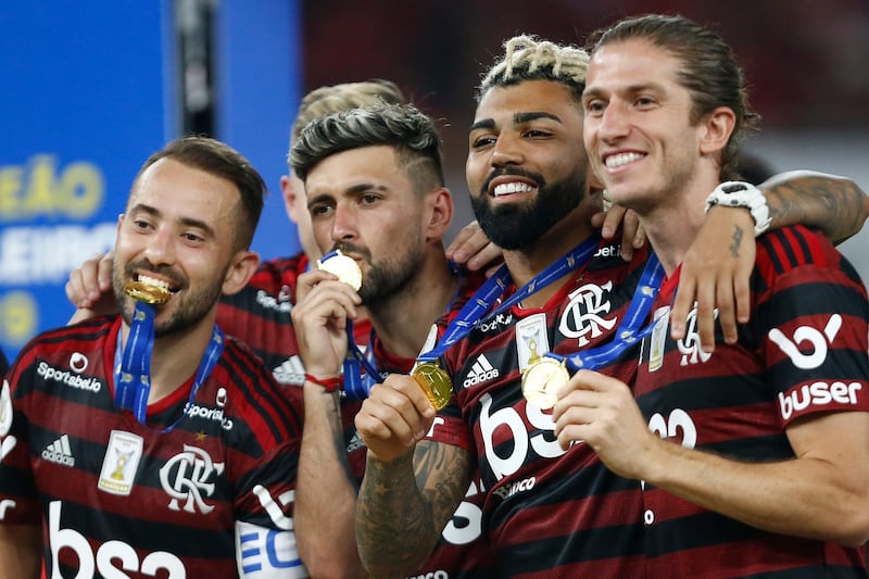 Everton Ribeiro, Arrascaeta, Gabriel Barbosa and Filipe Luis during the trophy ceremony after winning the Brasileirao 2019. Getty