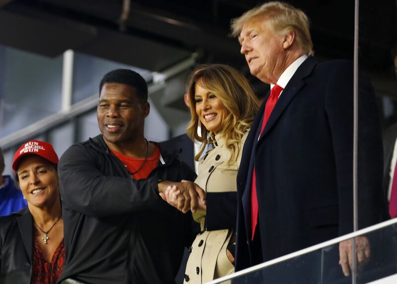 Herschel Walker with former US president Donald Trump at a World Series game between the Atlanta Braves and Houston Astros in Atlanta, Georgia.  Getty Images / AFP